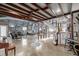 An open living area features exposed beams, unique decor, a staircase, and lots of space for entertaining at 410 Goodrich Ave, Platteville, CO 80651