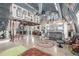 A spacious room featuring a lofted area, exposed beams and ductwork, and modern eclectic decor at 410 Goodrich Ave, Platteville, CO 80651
