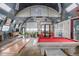 Spacious living area in a Quonset-style home with a pool table, skylights, and a projector screen at 410 Goodrich Ave, Platteville, CO 80651