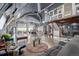 Spacious living room with vaulted ceilings, exposed ductwork, a projector screen, and unique decor throughout at 410 Goodrich Ave, Platteville, CO 80651