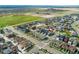 An aerial view of a residential neighborhood featuring modern homes and well-maintained streets, showcasing community layout at 20998 E 60Th Pl, Aurora, CO 80019