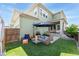 A lush, green backyard featuring an outdoor seating area and lush landscaping, perfect for relaxation at 20998 E 60Th Pl, Aurora, CO 80019