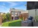 Serene backyard with a covered hot tub, seating area, lush landscaping, and privacy fencing at 20998 E 60Th Pl, Aurora, CO 80019