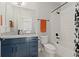Bathroom with navy vanity, granite countertops, white subway tile, and black matte fixtures at 20998 E 60Th Pl, Aurora, CO 80019