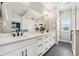 Bathroom with dual sinks, white countertops, black fixtures, and view to the primary bedroom at 20998 E 60Th Pl, Aurora, CO 80019