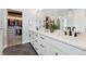 Bathroom with dual sink vanity, white countertops, modern fixtures and view to walk-in closet at 20998 E 60Th Pl, Aurora, CO 80019