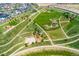 An aerial view of community park featuring winding paths, play areas, and lush greenery for outdoor enjoyment at 20998 E 60Th Pl, Aurora, CO 80019