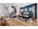 Elegant dining area with modern light fixture and staircase at 20998 E 60Th Pl, Aurora, CO 80019