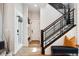 Entryway with wood floors, modern staircase, and a bench with a colorful pillow at 20998 E 60Th Pl, Aurora, CO 80019