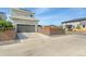 Spacious two-car garage with a concrete driveway, surrounded by a well-maintained fence and landscaping at 20998 E 60Th Pl, Aurora, CO 80019