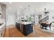 Open-concept kitchen and living area with hardwood floors and a central island at 20998 E 60Th Pl, Aurora, CO 80019