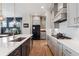 Kitchen with marble countertops, gray cabinets, a dark refrigerator, and stainless steel sink at 20998 E 60Th Pl, Aurora, CO 80019
