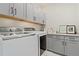 Bright laundry room with washer and dryer, ample storage, and granite countertops at 20998 E 60Th Pl, Aurora, CO 80019