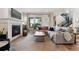 Comfortable living room featuring a fireplace and large windows at 20998 E 60Th Pl, Aurora, CO 80019