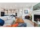 Cozy living room adjacent to an open kitchen with fireplace at 20998 E 60Th Pl, Aurora, CO 80019