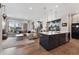 Open-concept living space with gourmet kitchen and cozy living area at 20998 E 60Th Pl, Aurora, CO 80019