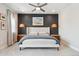 Spacious bedroom featuring modern decor, pendant lighting, a dark accent wall, and lots of natural light at 20998 E 60Th Pl, Aurora, CO 80019