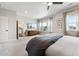Primary bedroom with large windows, dark accent wall, and modern furnishings for a relaxing retreat at 20998 E 60Th Pl, Aurora, CO 80019