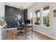 Well-lit office space with dark accent wall and modern chandelier at 20998 E 60Th Pl, Aurora, CO 80019