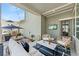 Covered outdoor patio area with comfortable seating, string lights, and a mounted flatscreen TV at 20998 E 60Th Pl, Aurora, CO 80019