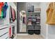 Well-appointed walk-in closet with full length mirror, closet system, and ample storage for clothing at 20998 E 60Th Pl, Aurora, CO 80019