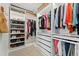 Organized walk-in closet featuring custom shelving, ample storage, and a bright, modern design at 20998 E 60Th Pl, Aurora, CO 80019