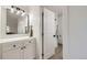 Bathroom with a mirror, vanity and an open door to a bathtub and shower at 1700 W 102Nd Ave, Thornton, CO 80260