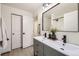 Bathroom featuring a double sink vanity, a mirror, and white cabinets at 1700 W 102Nd Ave, Thornton, CO 80260
