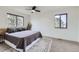 Bright bedroom with carpet, ceiling fan, and large windows offering natural light at 1700 W 102Nd Ave, Thornton, CO 80260