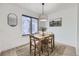 Bright dining area with modern lighting, natural wood table set, and large window at 1700 W 102Nd Ave, Thornton, CO 80260