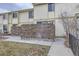 Cozy townhome with a brick walled patio, a grassy area, and a paved walkway at 1700 W 102Nd Ave, Thornton, CO 80260