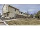 Pleasant townhome exterior with a brick privacy wall, green lawn, and paved walkway at 1700 W 102Nd Ave, Thornton, CO 80260