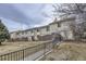 Inviting exterior of a townhome with a brick wall feature, a grassy area, and a walkway at 1700 W 102Nd Ave, Thornton, CO 80260