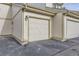 A well-maintained garage door with house numbers above it, next to another garage door at 1700 W 102Nd Ave, Thornton, CO 80260