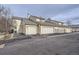 Attached garages in a townhome community with gray roof and an asphalt driveway at 1700 W 102Nd Ave, Thornton, CO 80260