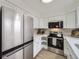 Well-equipped kitchen with stainless steel appliances, white cabinetry, and a modern backsplash at 1700 W 102Nd Ave, Thornton, CO 80260