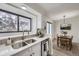 Clean kitchen with white cabinetry, stainless steel appliances, adjacent to dining area at 1700 W 102Nd Ave, Thornton, CO 80260