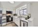 Bright kitchen featuring white cabinets, stainless steel appliances, quartz counters and an undermount sink at 1700 W 102Nd Ave, Thornton, CO 80260