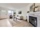 Bright living room featuring a fireplace, ample seating, large window, and modern decor at 1700 W 102Nd Ave, Thornton, CO 80260