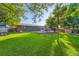 Manicured backyard featuring a deck with playset, lush lawn and privacy fence at 3643 E Lake Dr, Centennial, CO 80121