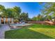 Grassy backyard featuring a covered patio, deck with a playset, privacy fence and mature trees at 3643 E Lake Dr, Centennial, CO 80121