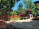 Spacious backyard featuring a stone patio, grassy area and a privacy fence with mature trees at 3643 E Lake Dr, Centennial, CO 80121