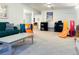Spacious carpeted basement area featuring play areas with slides, shelving, and a comfortable green sofa at 3643 E Lake Dr, Centennial, CO 80121