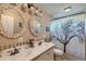 Bathroom featuring mosaic-framed mirrors, double sinks, and a decorative shower curtain at 3643 E Lake Dr, Centennial, CO 80121