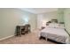 Well-lit bedroom featuring carpeted floor, bed, desk, and chair at 3643 E Lake Dr, Centennial, CO 80121