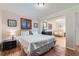 Bright bedroom features wood floors, shuttered window, and decorative artwork at 3643 E Lake Dr, Centennial, CO 80121