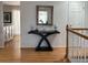 Inviting entryway featuring hardwood floors, a decor table with mirror, and a light-filled ambiance at 3643 E Lake Dr, Centennial, CO 80121