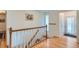 Inviting entryway featuring hardwood floors, a staircase, and a bright window with a light-filled ambiance at 3643 E Lake Dr, Centennial, CO 80121