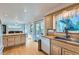 Bright kitchen with plenty of storage, butcher block countertop, and view into the dining area at 3643 E Lake Dr, Centennial, CO 80121