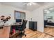 Home office with wood floors, a desk, and a large closet with mirrored doors at 3643 E Lake Dr, Centennial, CO 80121